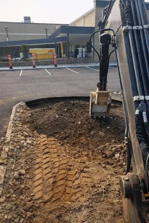Excavator performing coordinated site work