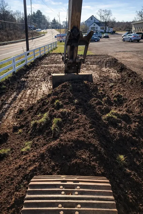 Excavator and truck working together on a property improvement